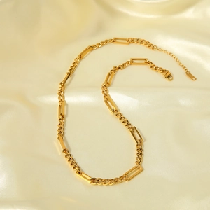 Gold plated thick chain necklace with square links on silk background for men and women