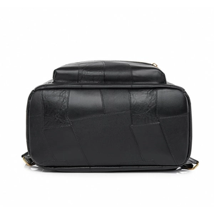 Detailed bottom view of black leather backpack featuring unique patchwork craftsmanship