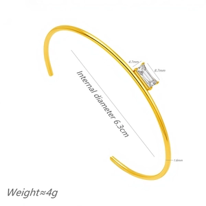 Minimalist gold titanium steel cuff bracelet featuring a square cubic zirconia stone