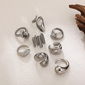 Artistic set of eight sculptural 18K geometric rings with fluid metal and knot designs