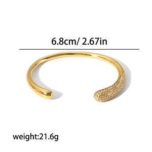 Polished 18k gold plated stainless steel open bangle featuring crystal pavé accents