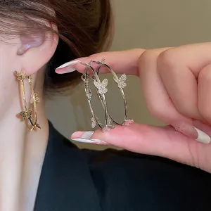 Elegant gold and silver butterfly hoop earrings with sparkling glitter for women