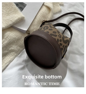 Detail of reinforced circular base on vintage brown jacquard bucket bag