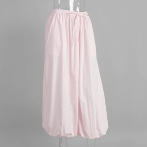 Detail of pink cotton lantern pants featuring elastic high waist and drawstring design