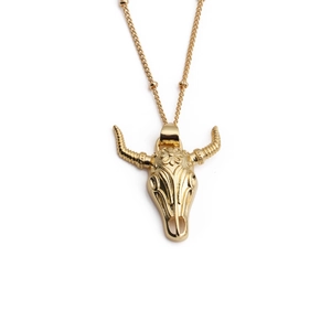 Golden bull skull necklace with sun engraving on a delicate ball chain for women