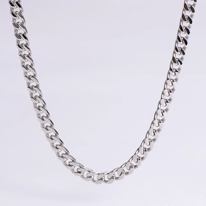 Detailed view of polished silver cuban link chain with high mirror finish metal texture