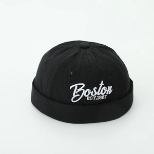Detail of Boston 1987 embroidery on a black cotton canvas docker hat with rolled edge