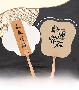 Detail of Chinese calligraphy hand fans in beige and white on a dark wood background