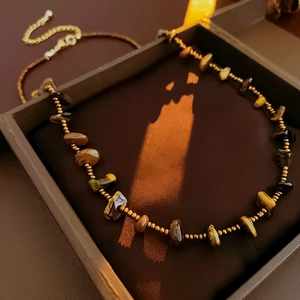 Tiger eye stone necklace with gold beads displayed in a professional jewelry gift box