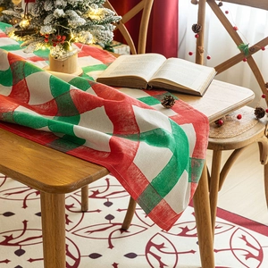 Christmas red and green plaid table runner with rustic pine cones and festive decor