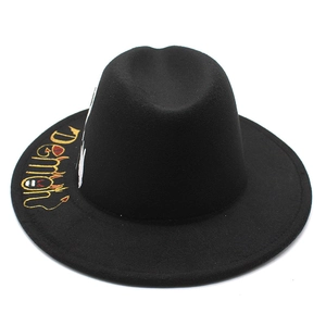Black wool fedora hat featuring yellow Demon embroidery with a stylish flat brim design