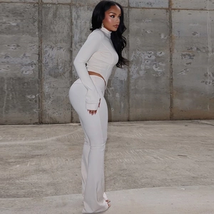 Chic white knit set featuring long sleeve high neck top and slim fit flared pants