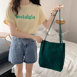 Detail view of a forest green cotton-linen tote bag showing vertical ribbed fabric texture