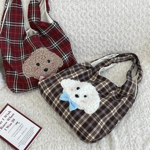 Detail of plaid tote bags with cute 3D plush puppy patches and colorful bows