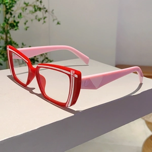 Close-up of red and pink anti-blue light glasses with white line detail and resin frame