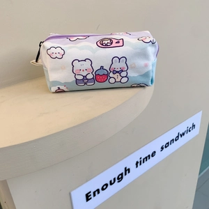 Detail of cute cartoon bear print on a lavender and blue canvas stationery pouch
