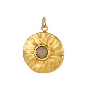 Detail of round gold pendant with sunburst texture and translucent grey center stone