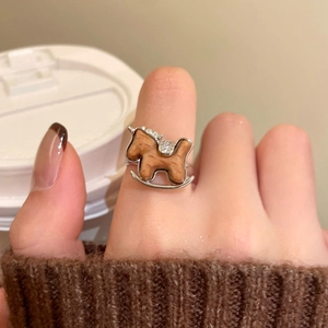 Close-up of retro rocking horse ring with zircon stones on female hand