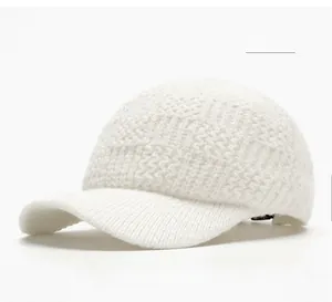Detailed herringbone knit texture of the off-white warm winter baseball cap