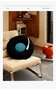Retro vinyl record plush pillow displayed on an armchair with aesthetic sunlight shadows