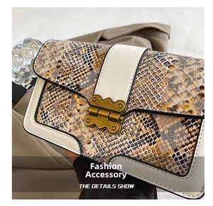 Close-up of snakeskin pattern leather handbag with vintage gold butterfly metal clasp