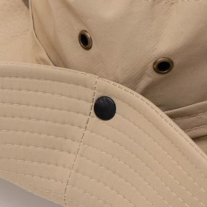 Detailed close-up of khaki outdoor sun hat featuring metal vents and reinforced stitching