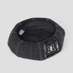 Dark grey denim beret hat with white contrast stitching and silver butterfly patch