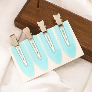 Set of four light blue leaf-shaped seamless hair clips for styling on white card