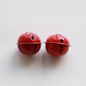 Two red 4cm star cutout metal bells for Christmas tree DIY decor on a white background