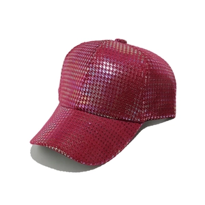 Detail of the holographic grid texture and metallic magenta finish on the baseball cap