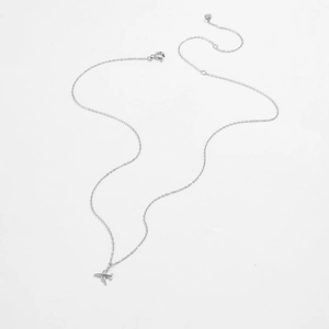 Detailed view of silver airplane pendant with lobster clasp and adjustable link chain