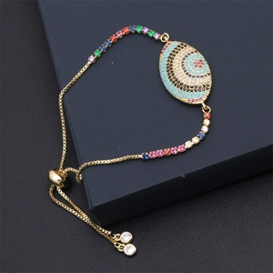 Macro shot of gold-plated evil eye bracelet with colorful zircons and adjustable chain