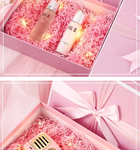 Detailed pink gift box with raffia filler, LED string lights and a silk ribbon bow