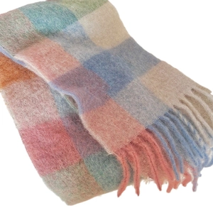 Thick colorful plaid winter scarf for women with soft fringe tassels on a white background