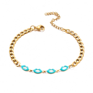 Detail of gold chain bracelet featuring four turquoise enamel lip pendants and lobster clasp