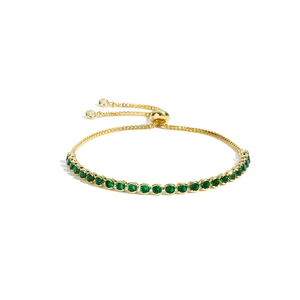 Adjustable gold tennis bracelet featuring round green zircons and a slider clasp closure