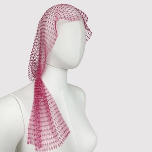 Detailed side view of rose red rhinestone mesh headpiece on a white mannequin head