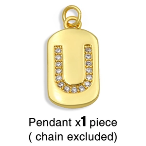 Detailed view of gold-plated U-letter pendant set with sparkling cubic zirconia stones