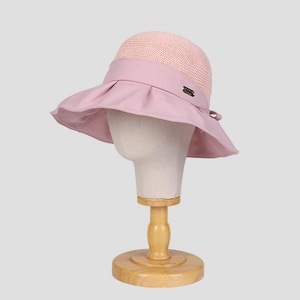 Detail of pink sun hat featuring breathable mesh crown and elegant side ribbon bow