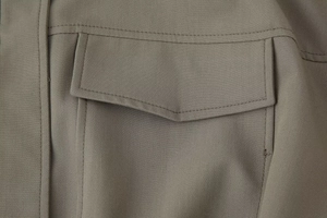 Macro view of twill fabric texture with flap pocket and double stitching detail