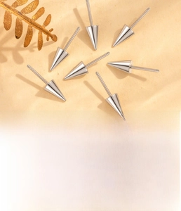 Macro shot of titanium steel cone screw back piercing parts in silver and gold finish