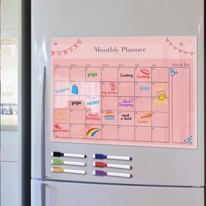 Pink acrylic monthly planner on fridge with 6 colored markers and written schedule