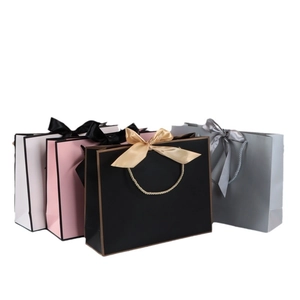 Elegant white card paper gift bags with decorative silk bows in four assorted colors