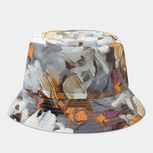 Detail of floral bucket hat featuring orange and grey abstract ink print and stitched brim