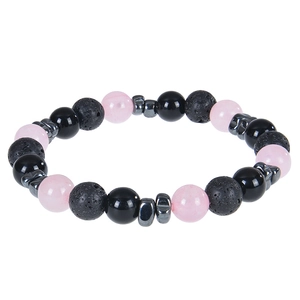 Macro detail of natural lava rock, pink beads, and polished black stones on a beaded bracelet