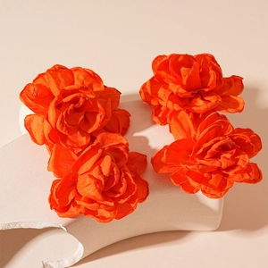Handcrafted orange fabric flower earrings with layered petals and a vintage aesthetic