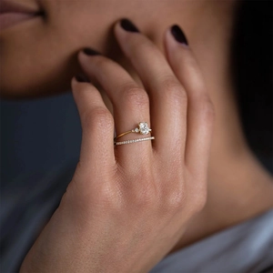 Detailed view of stacked S925 silver rings with square cut diamond and gold finish