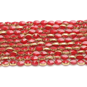 Macro view of red faceted glass beads with gold plated settings for DIY jewelry making