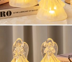 Detail of decorative LED angel figurines with warm glowing light on a cozy indoor table
