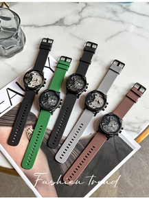 Flat lay of multi-color silicone strap sport watches with multi-dial design on a magazine